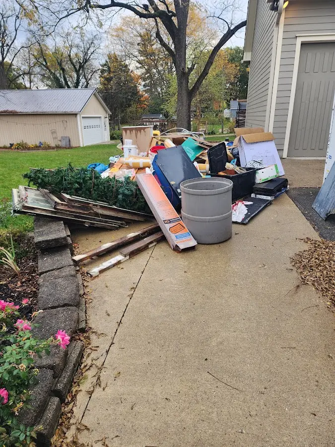 Dumpster being loaded with debris for Estate Cleanout Dumpster Rental in Chicago Ridge
